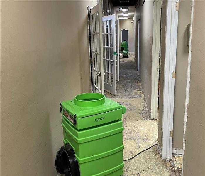 Dehumidifier set up in the hallway of a commercial building